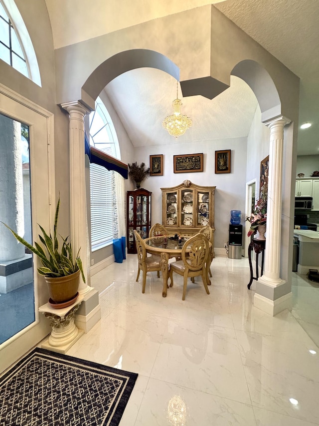 interior space with arched walkways, marble finish floor, and decorative columns