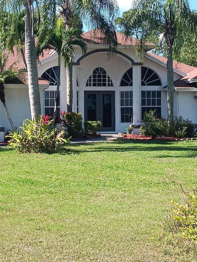 view of front of house featuring a front yard and stucco siding