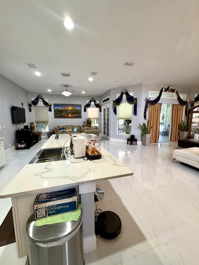 kitchen with recessed lighting, open floor plan, visible vents, and marble finish floor