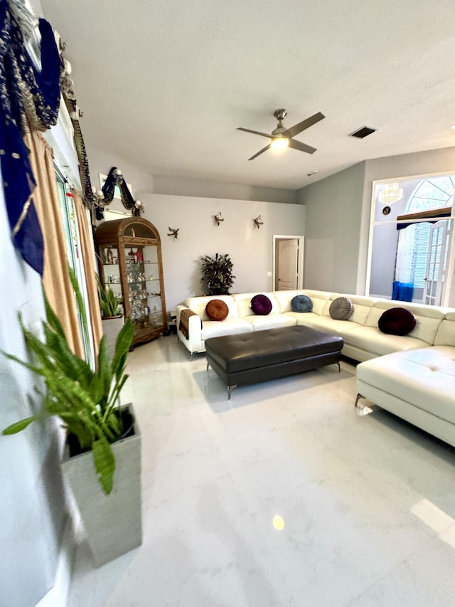 living room featuring visible vents and ceiling fan