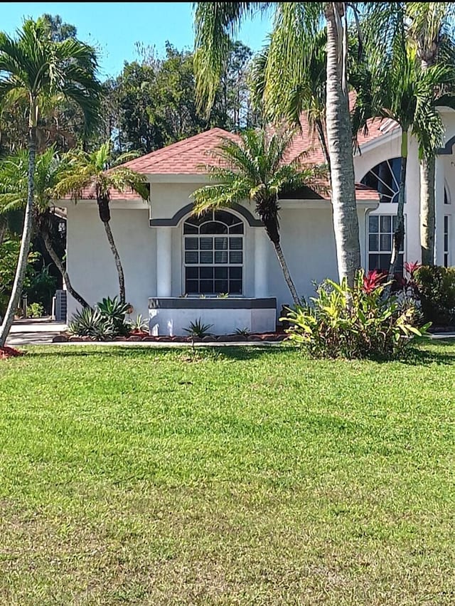 view of property exterior featuring a yard and stucco siding