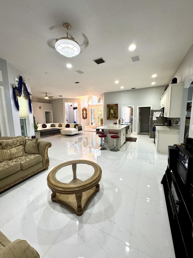 interior space featuring recessed lighting, marble finish floor, and visible vents