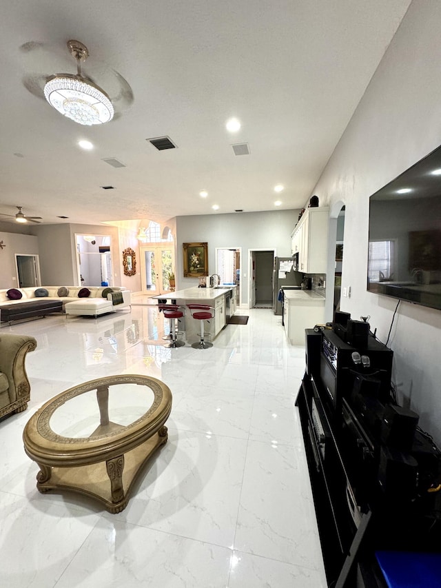 interior space with marble finish floor, visible vents, and recessed lighting