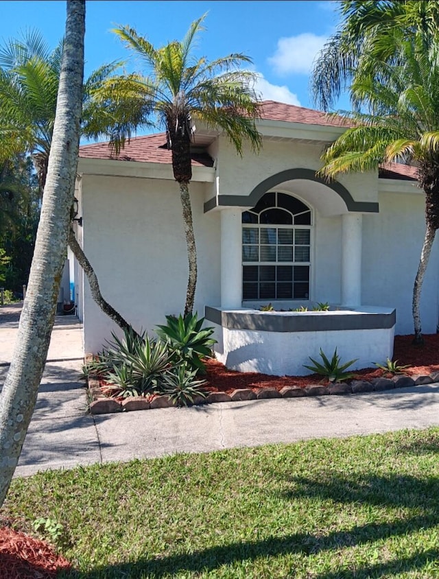 view of home's exterior featuring a shingled roof and stucco siding