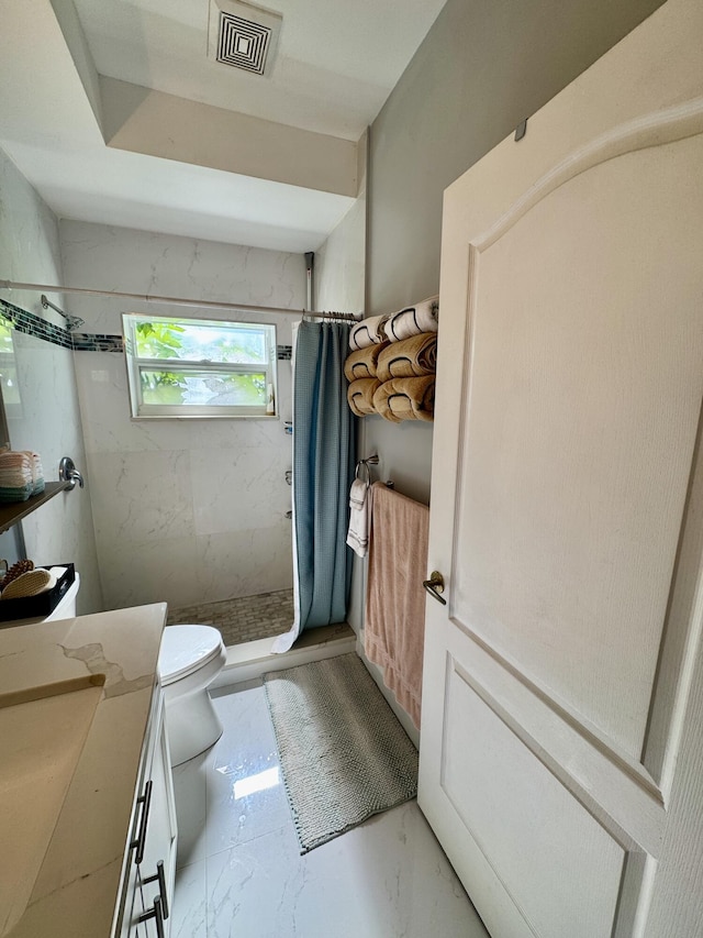 bathroom with toilet, vanity, visible vents, marble finish floor, and a stall shower