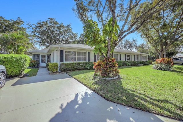 ranch-style home with brick siding and a front lawn