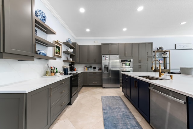 kitchen with open shelves, light countertops, appliances with stainless steel finishes, ornamental molding, and a sink