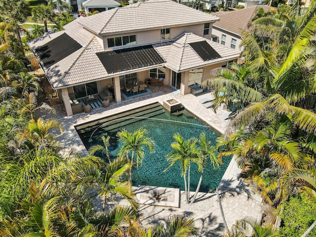 pool featuring a patio, an outdoor living space, and a jacuzzi