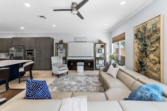 living area with light tile patterned floors, recessed lighting, visible vents, ornamental molding, and a ceiling fan