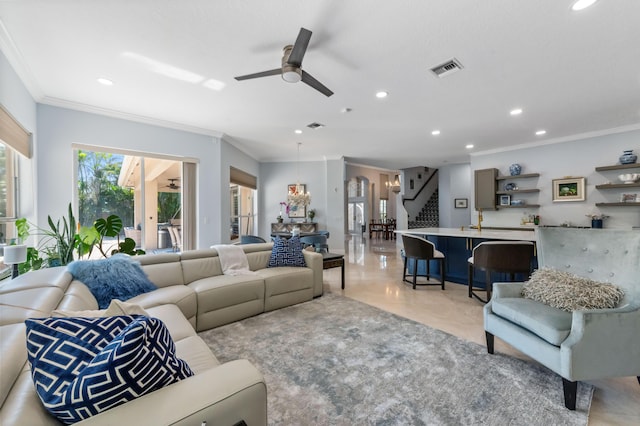 living room with stairway, recessed lighting, visible vents, and crown molding