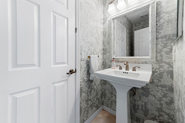 bathroom featuring tile patterned flooring, visible vents, baseboards, and wallpapered walls