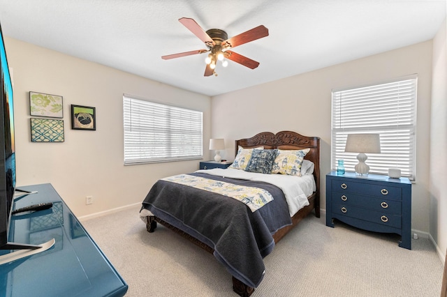 carpeted bedroom featuring a ceiling fan and baseboards