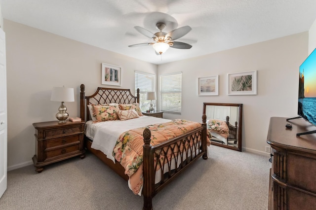 bedroom featuring light carpet, ceiling fan, and baseboards