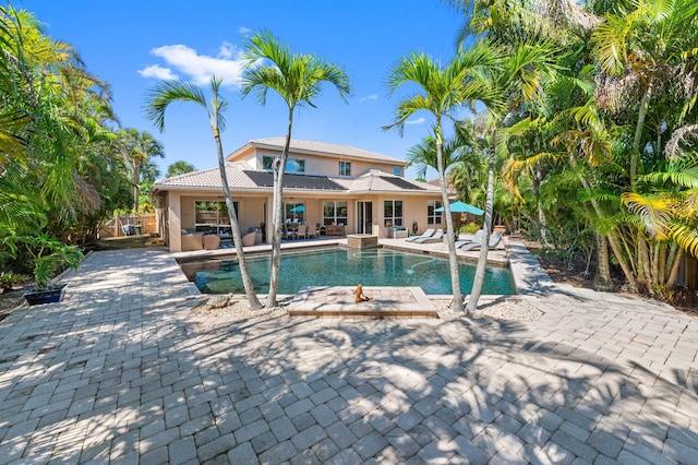 outdoor pool with a patio area and fence