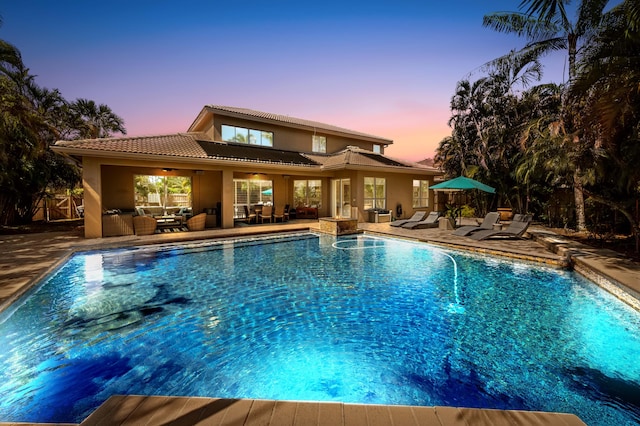 pool with a ceiling fan, a patio area, fence, and an outdoor hangout area