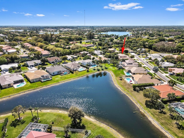 drone / aerial view with a water view and a residential view