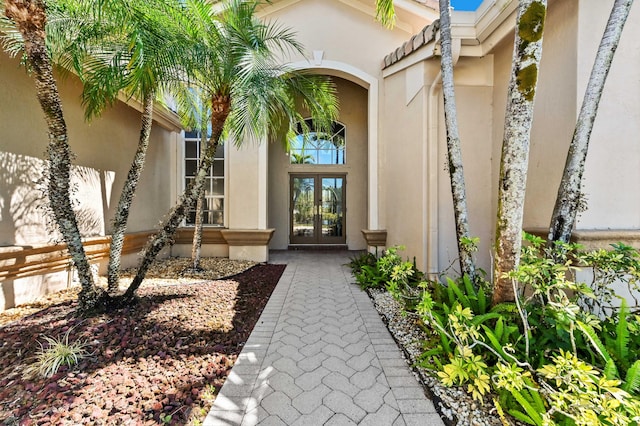 doorway to property with french doors and stucco siding