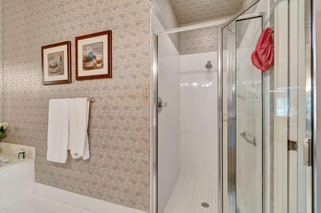 bathroom with tile patterned floors, a shower stall, a bath, and wallpapered walls