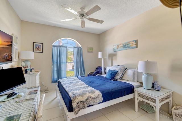 6367 Long Key Ln, Boynton Beach, FL 33472 - bedroom featuring a textured ceiling, light tile patterned floors, and a ceiling fan