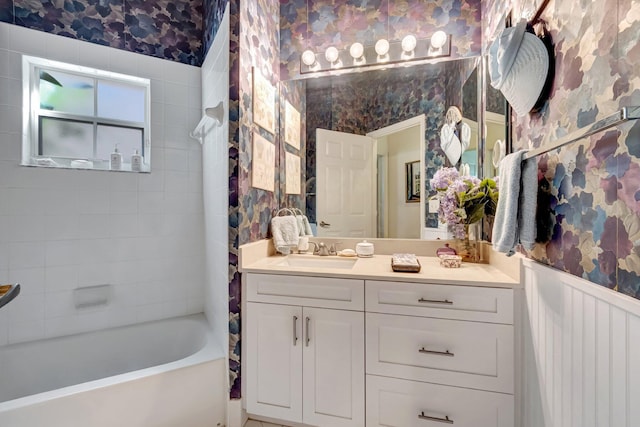 full bath featuring a wainscoted wall, vanity, and wallpapered walls