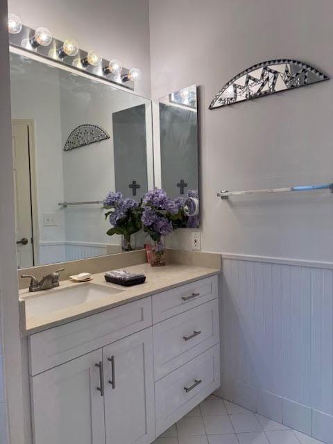 6367 Long Key Ln, Boynton Beach, FL 33472 - bathroom with wainscoting, vanity, and tile patterned flooring
