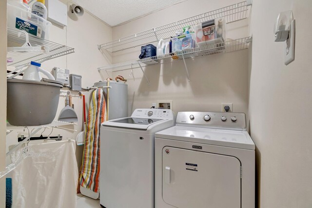 clothes washing area with washer and dryer and laundry area