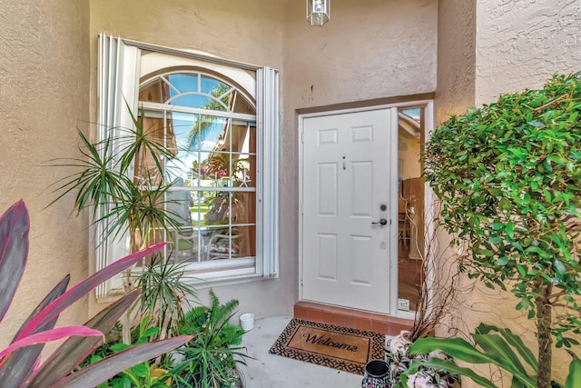 property entrance with stucco siding