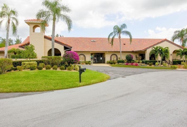 6367 Long Key Ln, Boynton Beach, FL 33472 - view of front of home with stucco siding, a front yard, curved driveway, and a tile roof