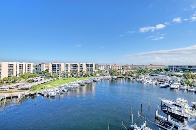 property view of water featuring a dock and a city view