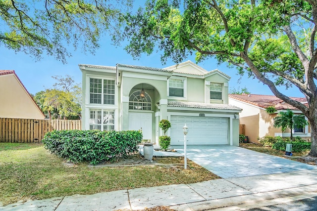 view of front of home with a garage, a tile roof, fence, driveway, and stucco siding