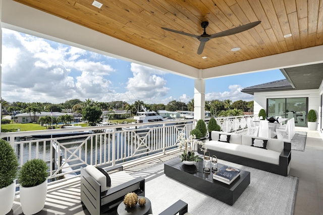 view of patio with ceiling fan, outdoor dining area, a water view, and an outdoor hangout area