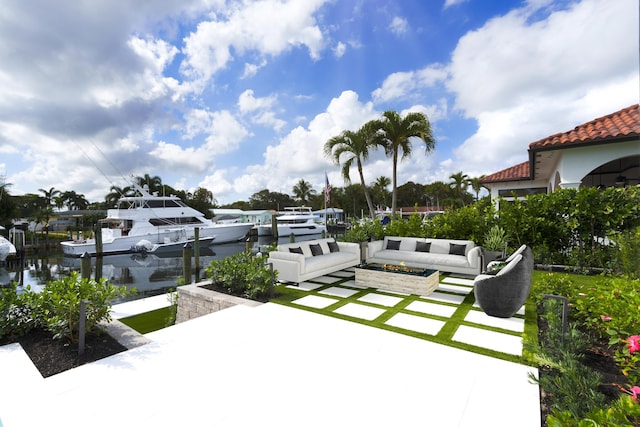 view of patio with outdoor lounge area, a dock, and a water view