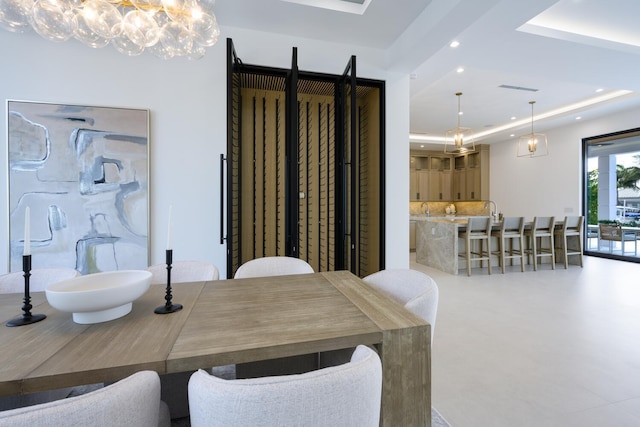 dining room featuring recessed lighting, a raised ceiling, visible vents, and an inviting chandelier
