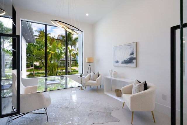 sitting room with recessed lighting and a notable chandelier