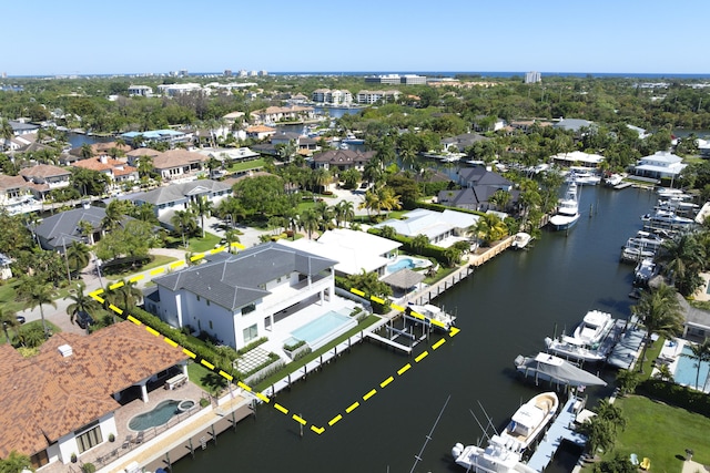 drone / aerial view featuring a residential view and a water view