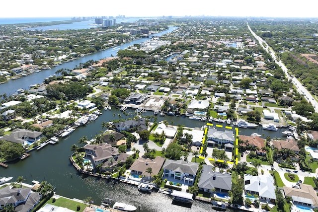 drone / aerial view featuring a residential view and a water view