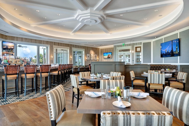 dining space with beam ceiling, recessed lighting, wood finished floors, coffered ceiling, and a ceiling fan