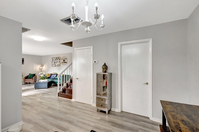 dining space with light wood-style floors, baseboards, and an inviting chandelier