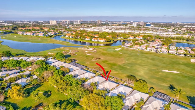 drone / aerial view with a residential view, a water view, and golf course view