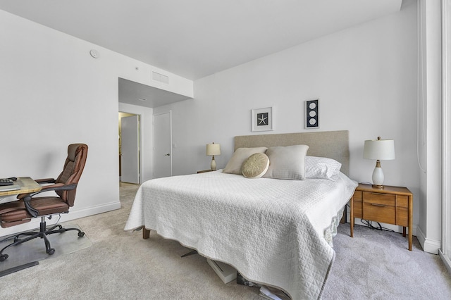 carpeted bedroom featuring baseboards and visible vents