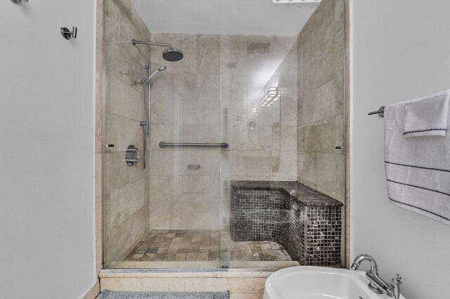 full bath featuring a shower stall and a sink