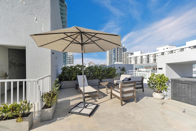 view of patio / terrace with a view of city and outdoor lounge area