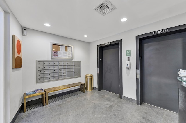 corridor with visible vents, mail area, concrete flooring, elevator, and recessed lighting