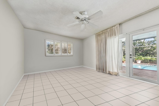 unfurnished room with ceiling fan, french doors, a textured ceiling, and baseboards