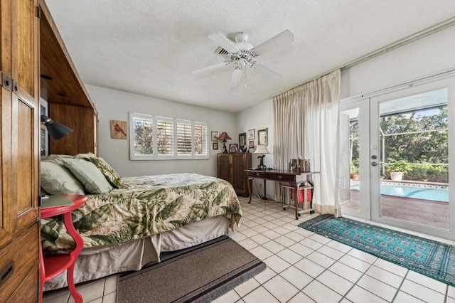 bedroom with light tile patterned floors, a textured ceiling, and access to exterior