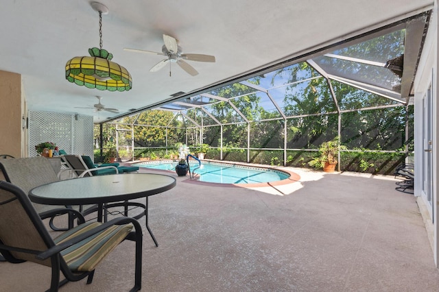 outdoor pool with a lanai, a patio, and ceiling fan