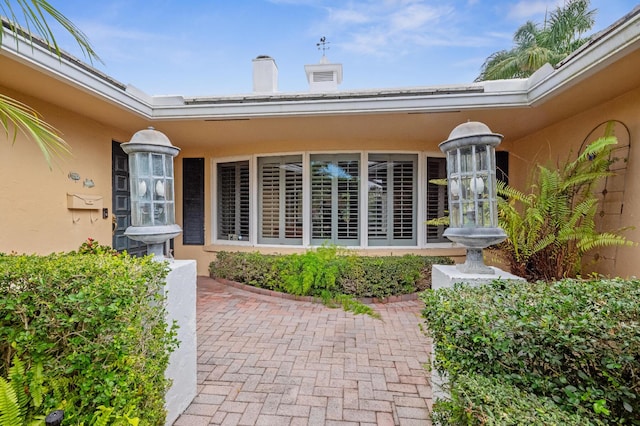 doorway to property with stucco siding