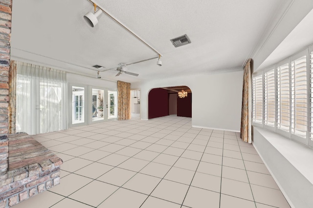 interior space featuring visible vents, arched walkways, ceiling fan, a textured ceiling, and track lighting