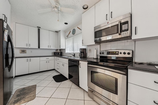 kitchen featuring dark countertops, light tile patterned flooring, white cabinetry, a textured ceiling, and black appliances