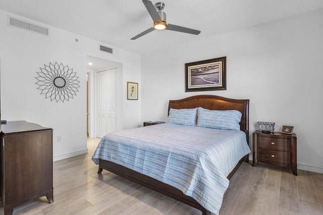 bedroom featuring a closet, visible vents, and light wood finished floors